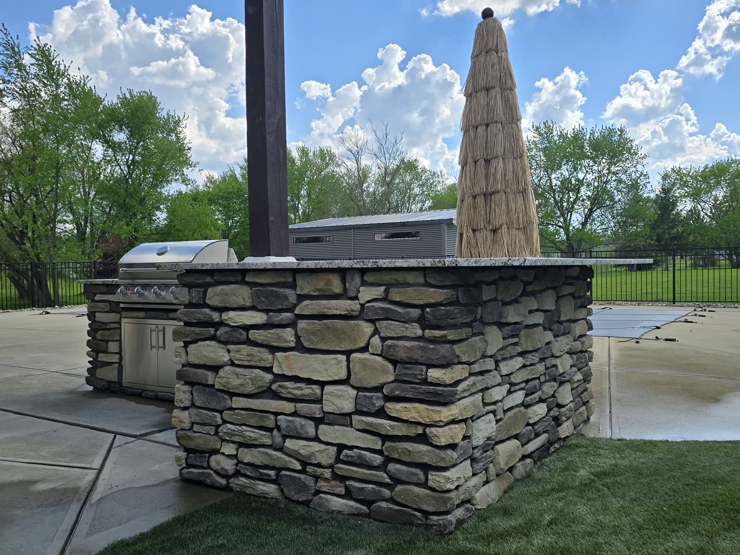 Finished paver patio with a built-in seat wall and outdoor gathering space