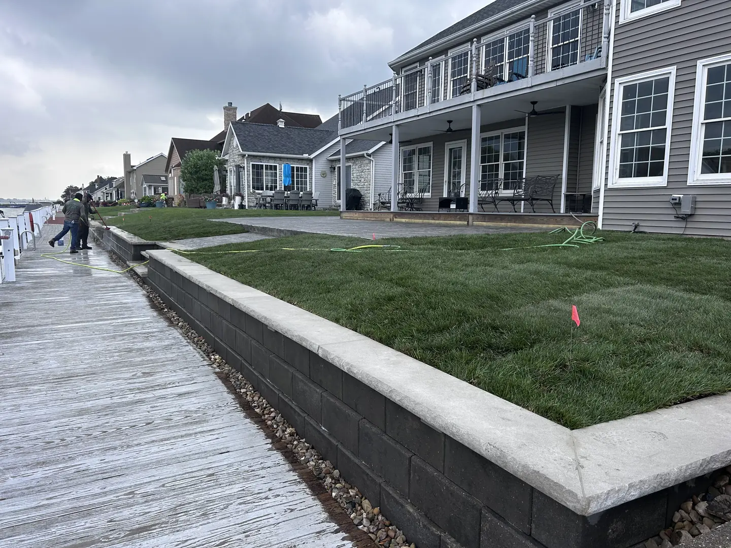 Finished lakeside backyard with new sod and stone retaining wall