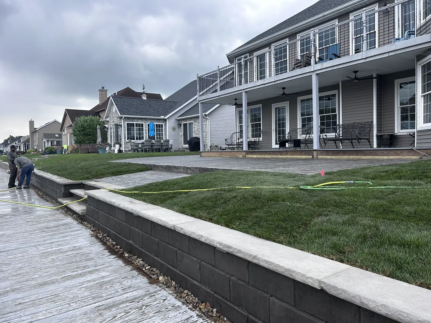 Finished lakeside backyard with new sod and stone retaining wall