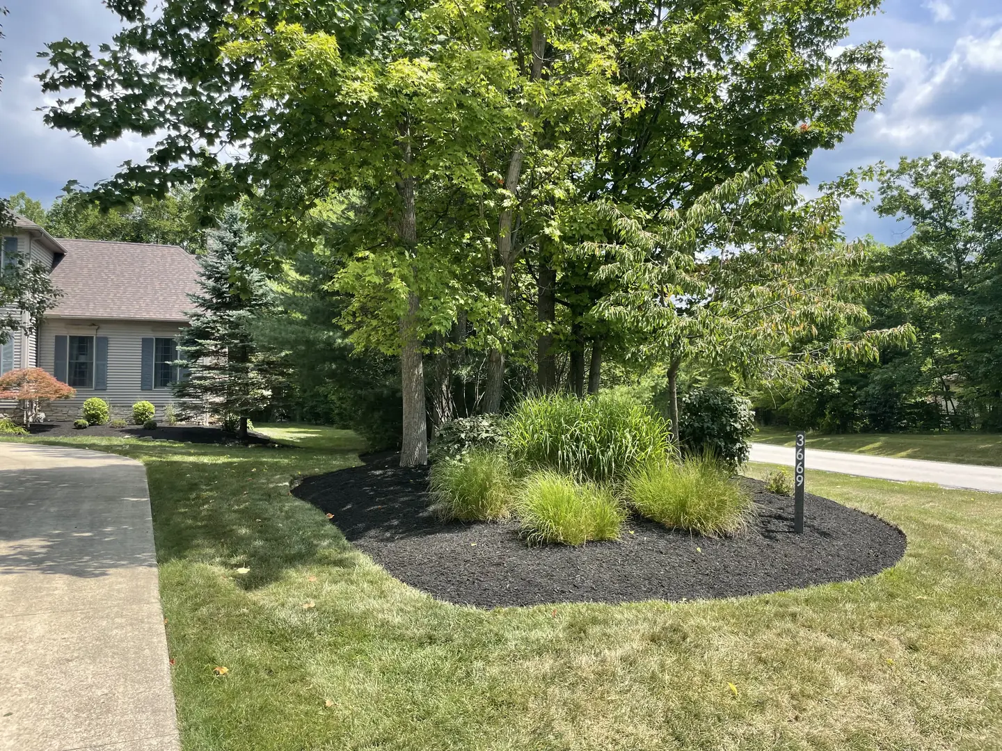 Finished residential landscape with fresh dark mulch
