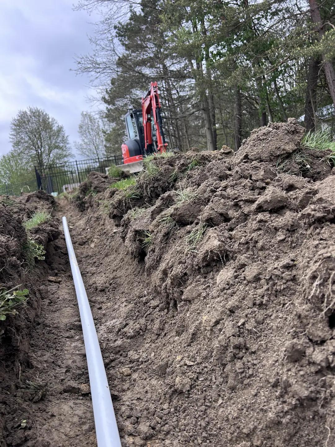 Drainage, excavation, and base preparation on an active job site