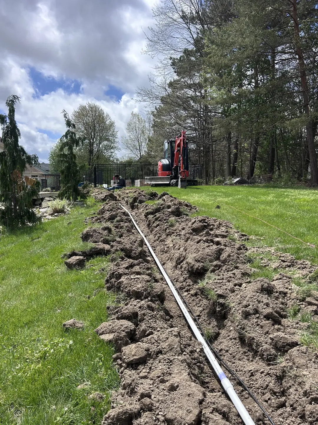 Drainage, excavation, and base preparation on an active job site