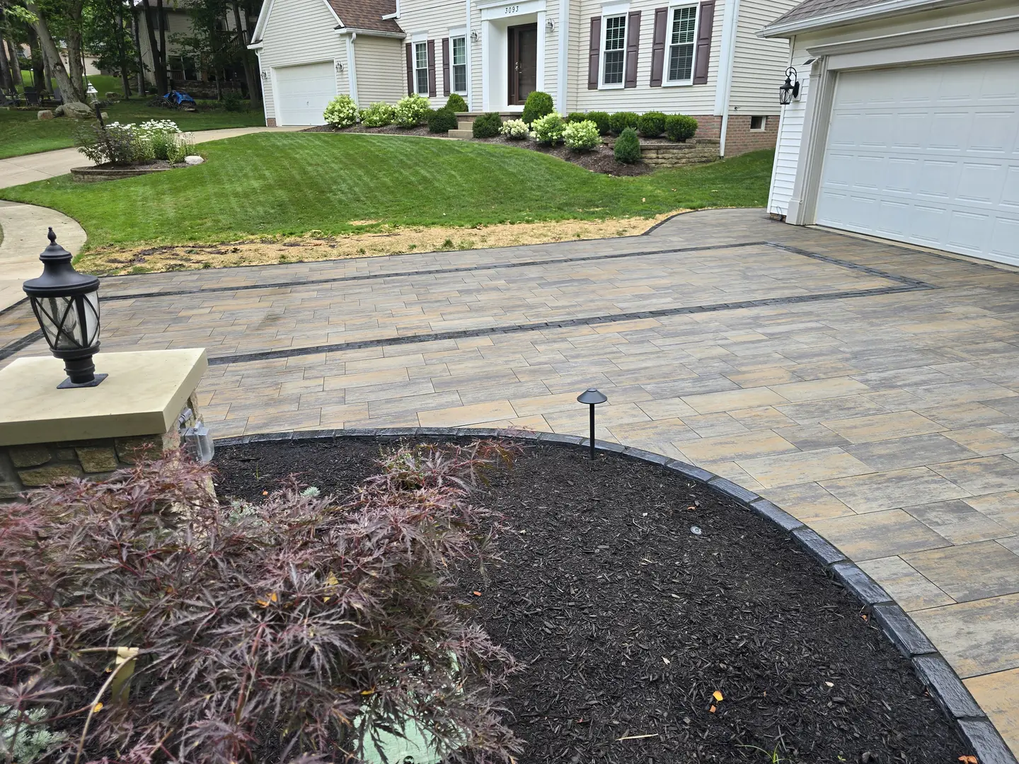 Finished paver driveway and landscaped front entry
