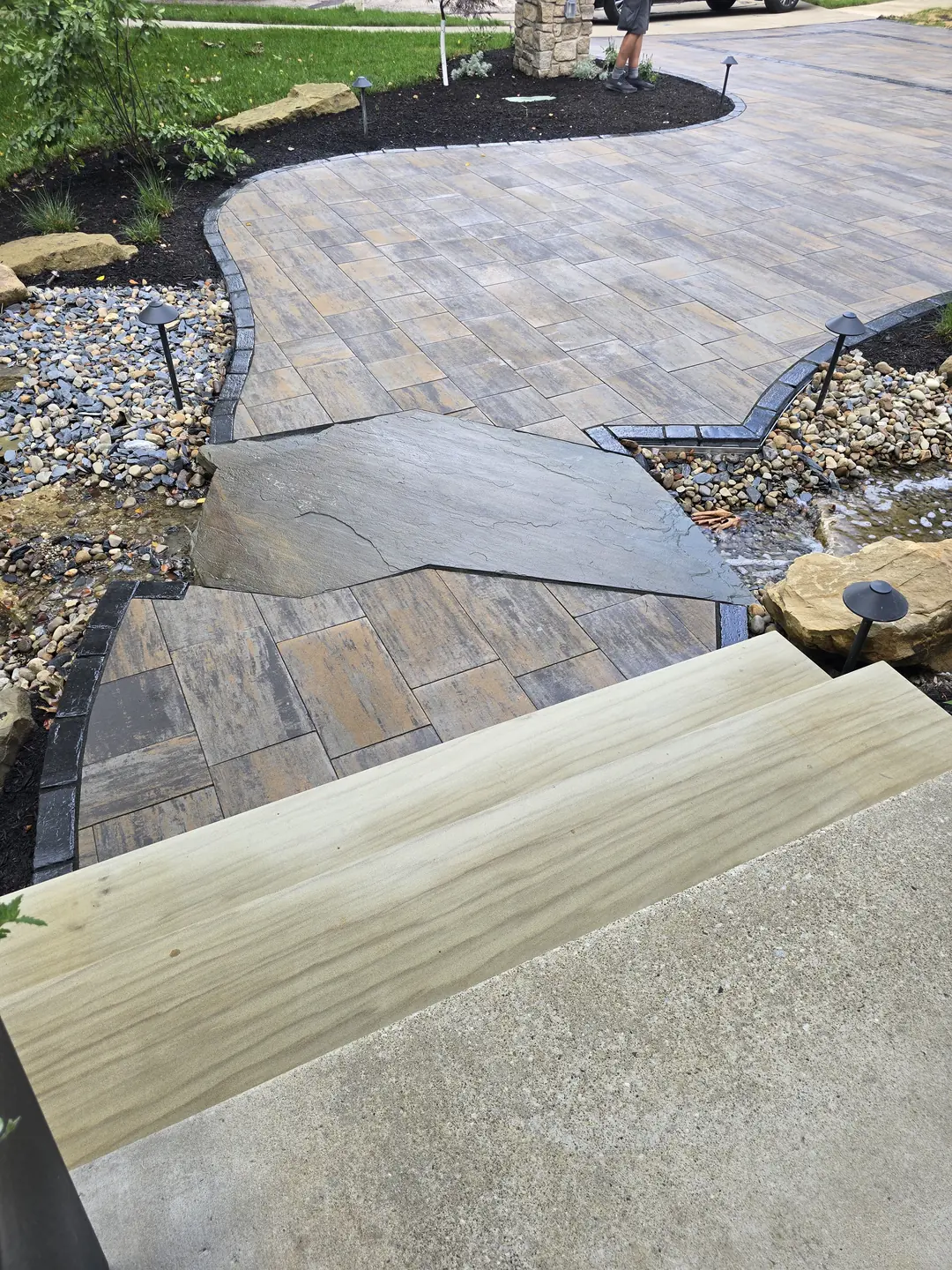 Landscape water feature and natural stone details at a Stow property