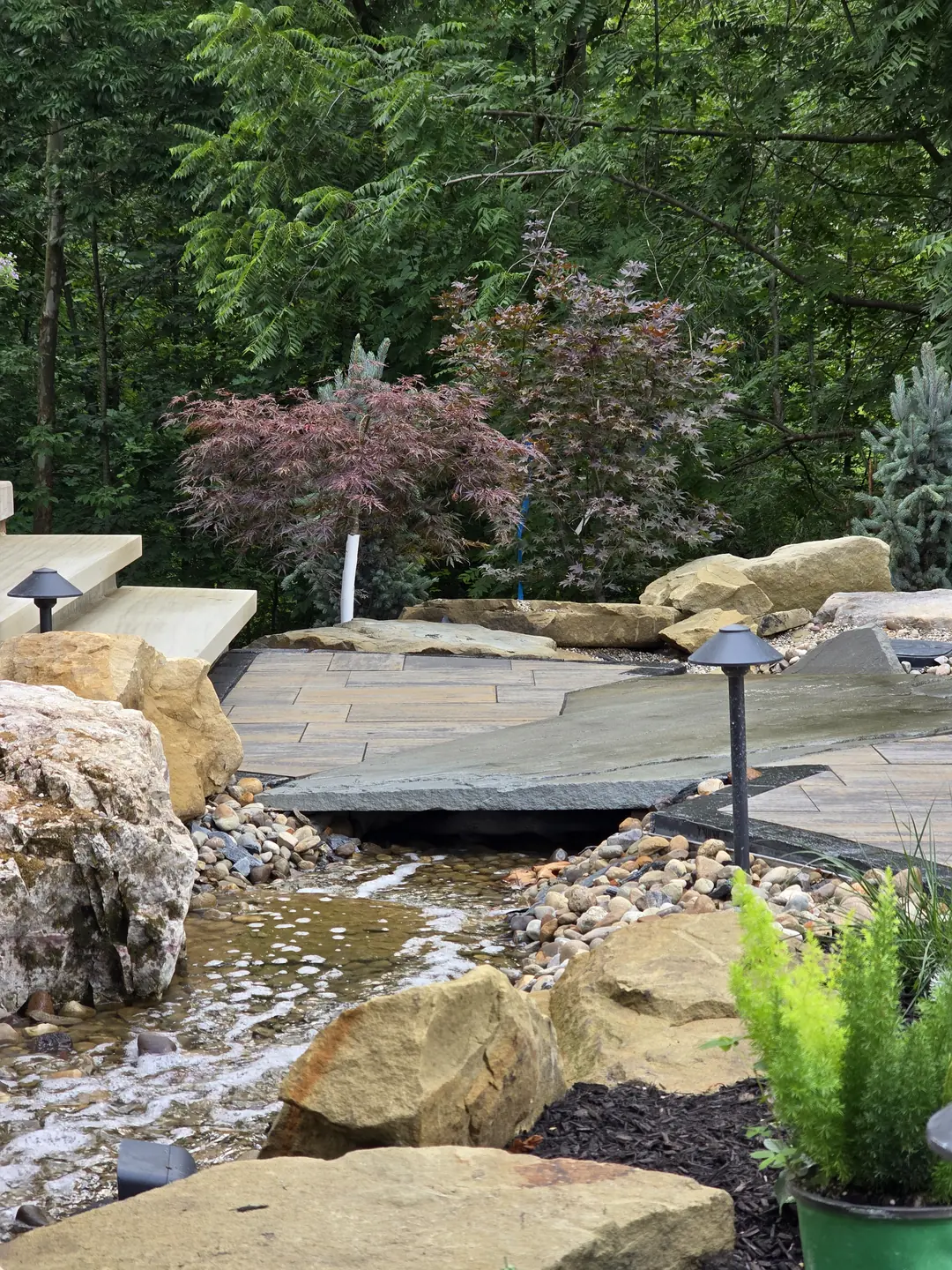 Landscape water feature and natural stone details at a Stow property