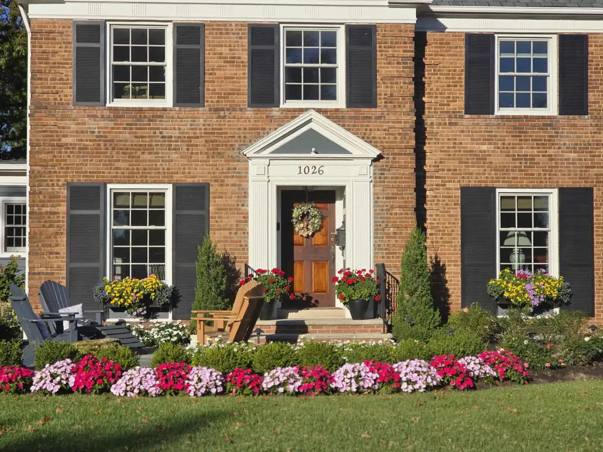 Brick home with colorful flower plantings