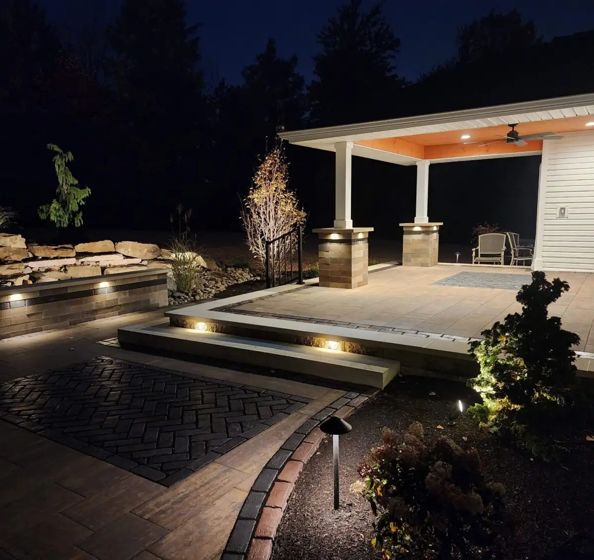 Night patio with pergola and landscape lighting