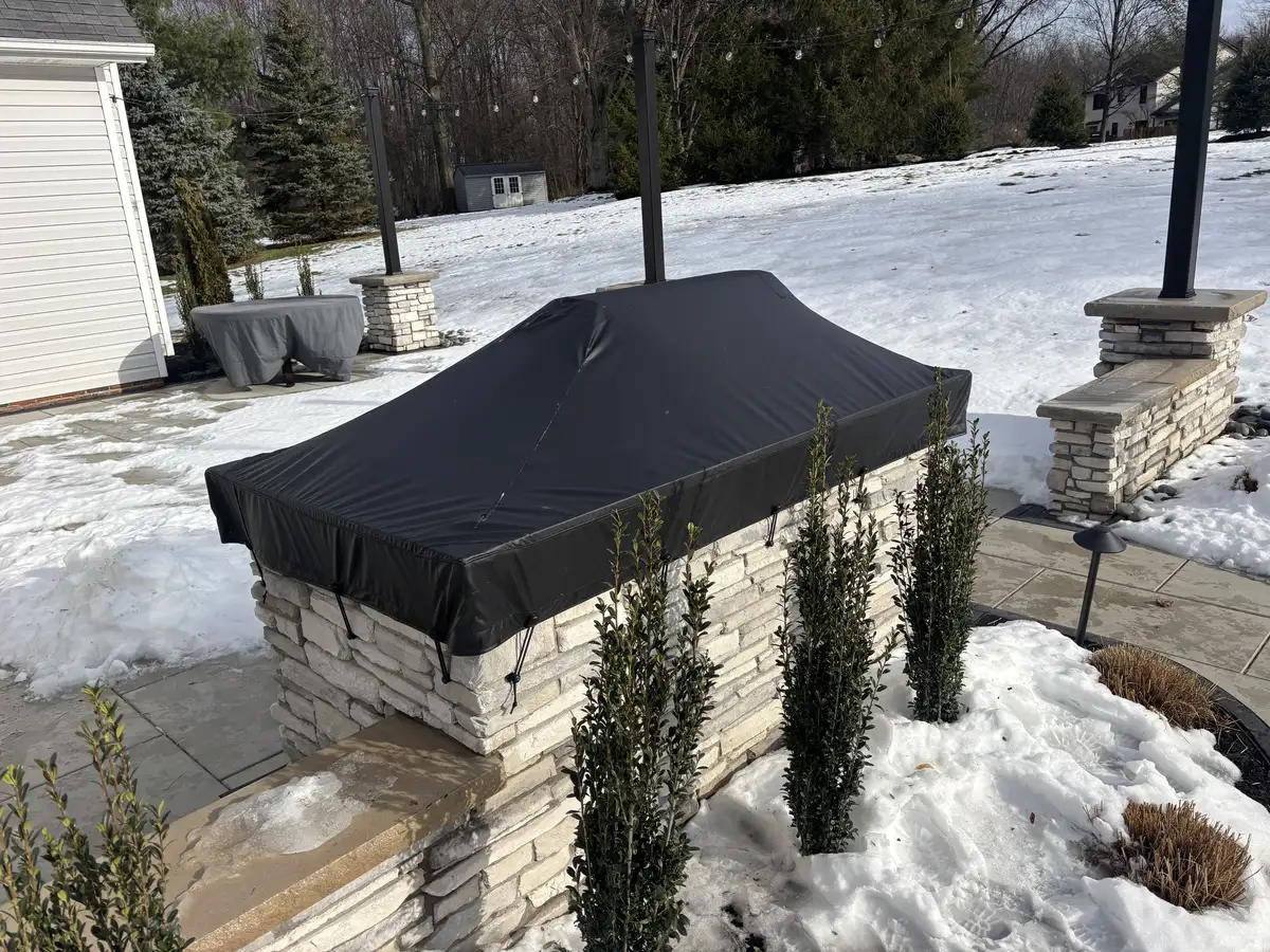 Built-in outdoor kitchen with stainless grill and granite countertop