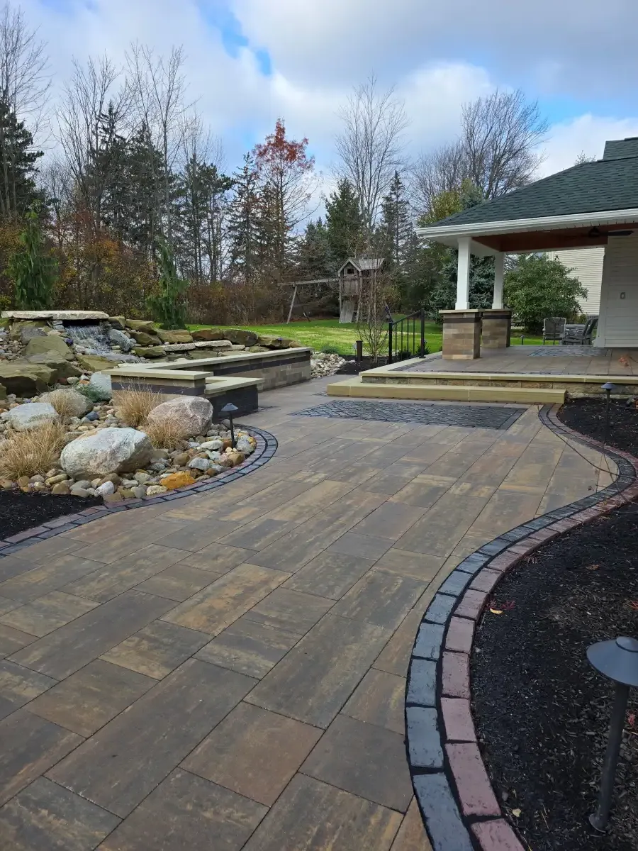 Retaining wall with landscaping by A.J. Kraig