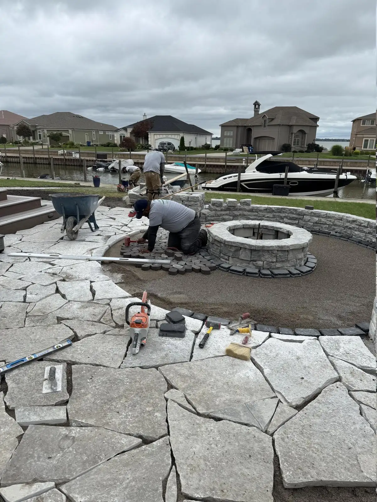 A.J. Kraig crew installing stone patio and fire pit at Marblehead lakefront property