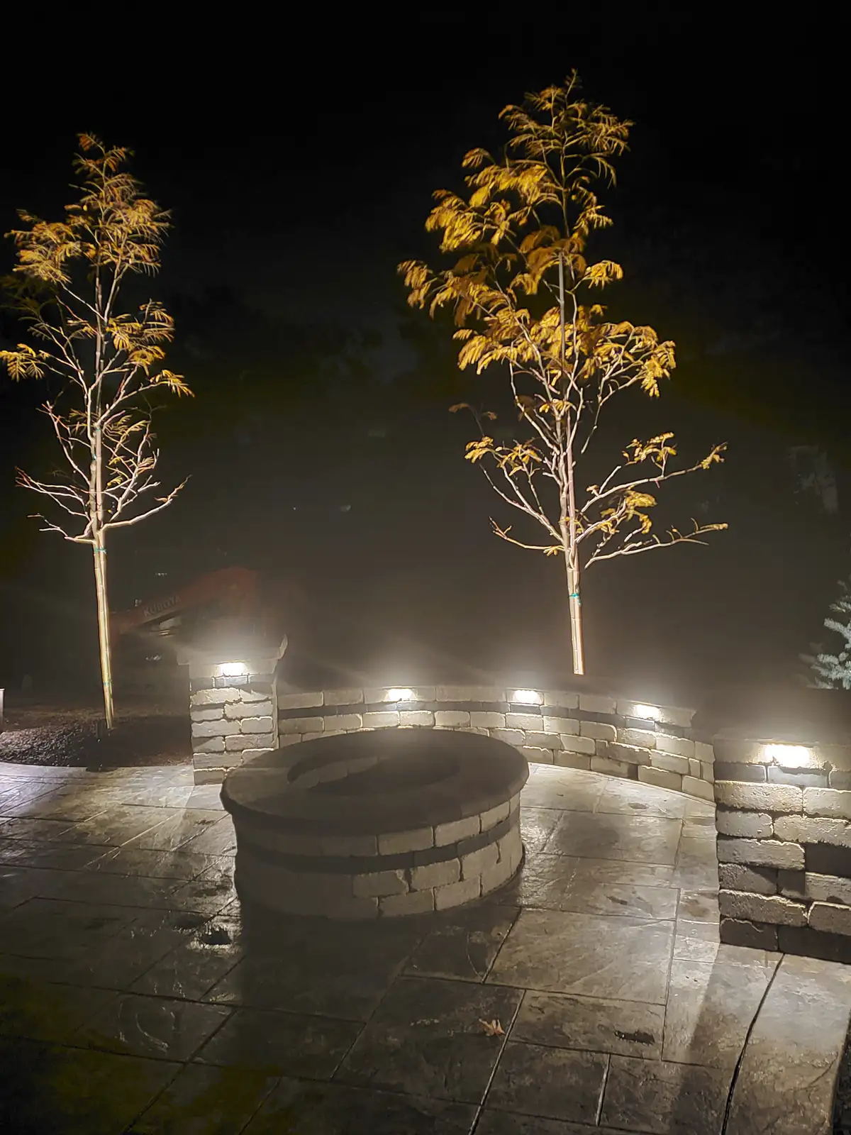 Spotlight on landscape feature and stone wall