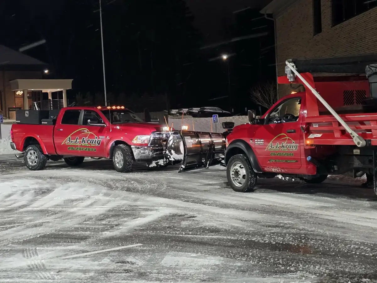 Snow plow truck clearing commercial lot